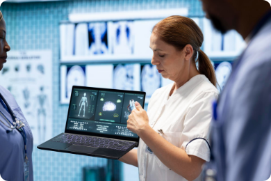 Healthcare professionals using health-tech to analyze a patient's electronic health records (EHR) and diagnostic scans on a laptop, emphasizing teamwork and accurate medical diagnosis.