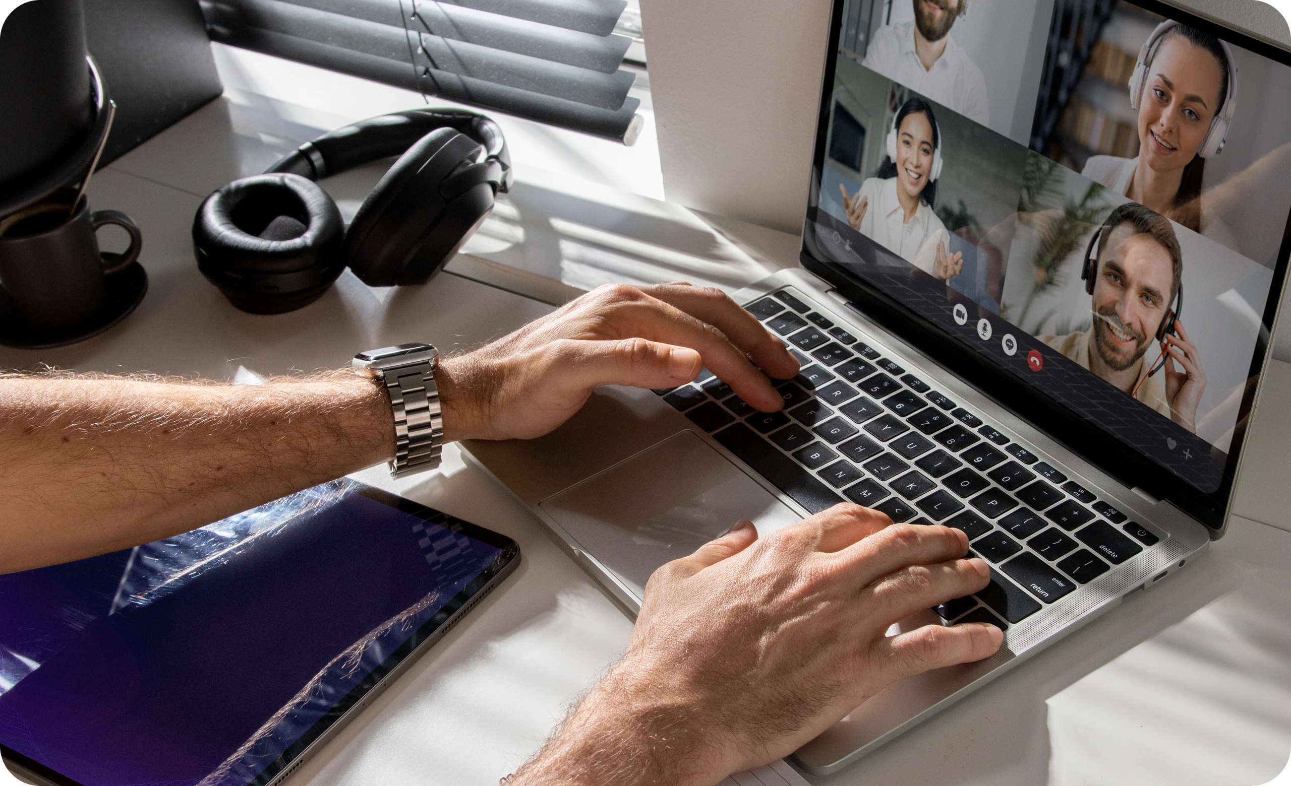 Person participating in a remote video conference on a laptop with healthcare professionals—highlighting virtual collaboration and telehealth integration in AI medical coding solutions.