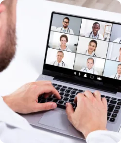 Group of doctors in a virtual video conference on a laptop screen—demonstrating AI telemedicine collaboration, remote consultations, and digital healthcare teamwork.